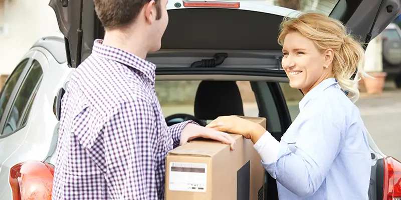 a couple unloading a car